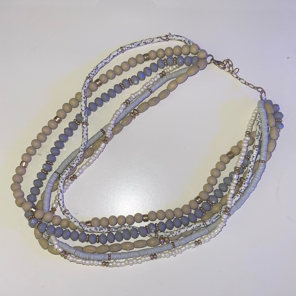 Neutral colored stacked necklaces